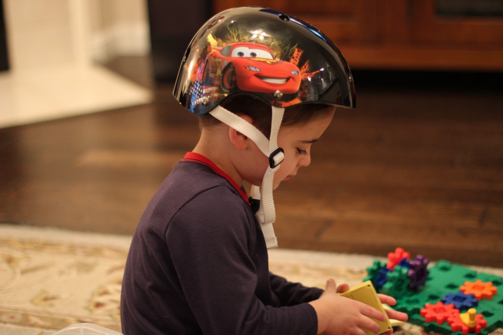 (James wearing his new helmet and playing with his new toys.)